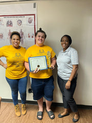 Funeral service camper with completion certificate, with Madeline Lyles and Dana Taylor